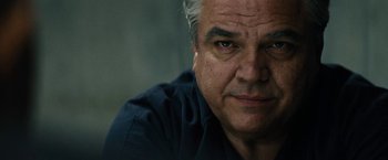 Movie still from “Black Mass” (2015), directed by Scott Cooper – An older man with gray hair stares into the camera; Close Up shot, Low angle