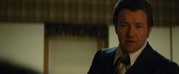 Movie still from “Black Mass” (2015), directed by Scott Cooper – A person wearing a suit and tie; Close Up shot, Low angle