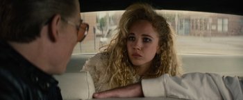 Movie still from “Black Mass” (2015), directed by Scott Cooper – A woman sitting in the back seat of a car; Close Up shot, Over the shoulder angle