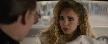 Movie still from “Black Mass” (2015), directed by Scott Cooper – A woman with long blonde hair sitting in a car; Close Up shot, Over the shoulder angle
