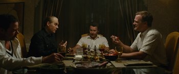Movie still from “Black Mass” (2015), directed by Scott Cooper – A group of people sitting around a dinner table; Medium shot, High angle
