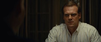 Movie still from “Black Mass” (2015), directed by Scott Cooper – A person wearing a white shirt; Close Up shot, Over the shoulder angle