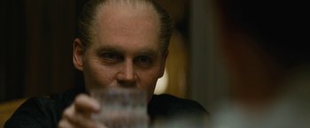 Movie still from “Black Mass” (2015), directed by Scott Cooper – A person drinking a glass of water; Close Up shot, Over the shoulder angle