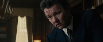 Movie still from “Black Mass” (2015), directed by Scott Cooper – A person wearing a suit and tie; Close Up shot, Over the shoulder angle