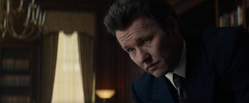 Movie still from “Black Mass” (2015), directed by Scott Cooper – A person wearing a suit and tie; Close Up shot, Low angle