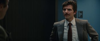 Movie still from “Black Mass” (2015), directed by Scott Cooper – A person wearing a suit and tie; Close Up shot, Over the shoulder angle
