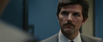 Movie still from “Black Mass” (2015), directed by Scott Cooper – A person wearing a suit and tie; Close Up shot, Over the shoulder angle