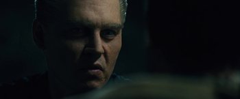 Movie still from “Black Mass” (2015), directed by Scott Cooper – A person looking at the camera; Close Up shot, Over the shoulder angle