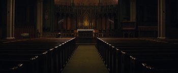 Movie still from “Black Mass” (2015), directed by Scott Cooper – An empty church with pews in front of the alter; Extreme Wide shot, High angle