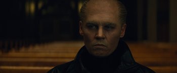 Movie still from “Black Mass” (2015), directed by Scott Cooper – A person wearing a black jacket; Close Up shot, Low angle
