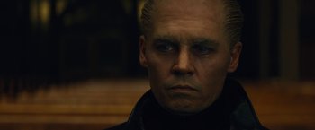 Movie still from “Black Mass” (2015), directed by Scott Cooper – A person wearing a black jacket; Close Up shot, Low angle