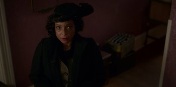 Movie still from “Fargo” (2014), created by Noah Hawley – A woman wearing a black hat and a black jacket; Close Up shot, Over the shoulder angle