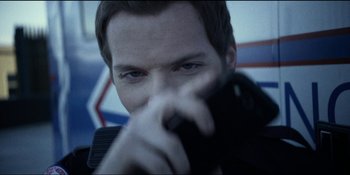 Movie still from “Blair Witch” (2016), directed by Adam Wingard – A person holding a gun; Close Up shot, Over the shoulder angle