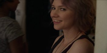 Movie still from “Blair Witch” (2016), directed by Adam Wingard – A beautiful woman with long blonde hair wearing a black top; Close Up shot, Over the shoulder angle