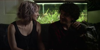 Movie still from “Blair Witch” (2016), directed by Adam Wingard – A man and a woman sitting next to each other on a bus; Medium shot, Over the shoulder angle