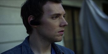 Movie still from “Blair Witch” (2016), directed by Adam Wingard – A person wearing a headset; Close Up shot, Over the shoulder angle