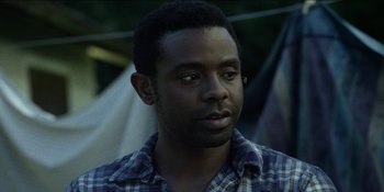 Movie still from “Blair Witch” (2016), directed by Adam Wingard – A person wearing a plaid shirt; Close Up shot, Over the shoulder angle