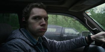Movie still from “Blair Witch” (2016), directed by Adam Wingard – A man sitting in the driver's seat of a car; Close Up shot, Low angle
