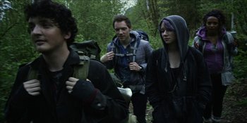 Movie still from “Blair Witch” (2016), directed by Adam Wingard – A group of young people walking through the woods; Medium shot, Low angle
