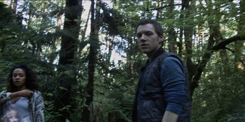 Movie still from “Blair Witch” (2016), directed by Adam Wingard – A man standing in the middle of a forest; Close Up shot, Low angle