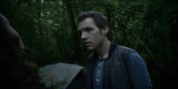 Movie still from “Blair Witch” (2016), directed by Adam Wingard – A man standing in the middle of a forest; Close Up shot, Over the shoulder angle