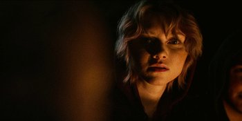 Movie still from “Blair Witch” (2016), directed by Adam Wingard – A young woman with blonde curly hair looking at the camera; Close Up shot, Low angle