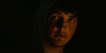 Movie still from “Blair Witch” (2016), directed by Adam Wingard – A person wearing a hooded sweatshirt; Close Up shot, Low angle