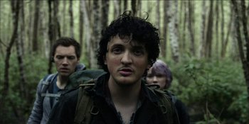 Movie still from “Blair Witch” (2016), directed by Adam Wingard – A group of people standing next to each other in the woods; Close Up shot, Low angle