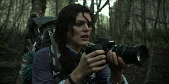 Movie still from “Blair Witch” (2016), directed by Adam Wingard – A woman holding a camera in the woods; Close Up shot, Low angle