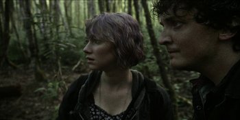 Movie still from “Blair Witch” (2016), directed by Adam Wingard – A woman and a man standing next to each other in the woods; Close Up shot, Low angle