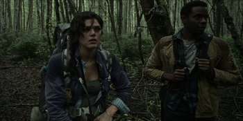 Movie still from “Blair Witch” (2016), directed by Adam Wingard – Two people in the woods with backpacks on; Medium shot, Low angle