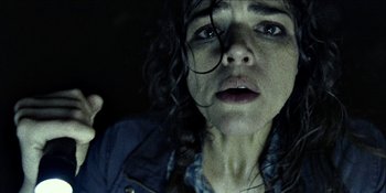 Movie still from “Blair Witch” (2016), directed by Adam Wingard – A person with wet hair looking at the camera; Close Up shot, Overhead angle