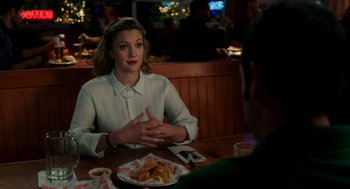 Movie still from “Blended” (2014), directed by Frank Coraci – A woman sitting in front of a plate of food; Medium shot, Over the shoulder angle