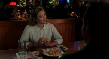 Movie still from “Blended” (2014), directed by Frank Coraci – A woman sitting at a table with a plate of food; Medium shot, Over the shoulder angle