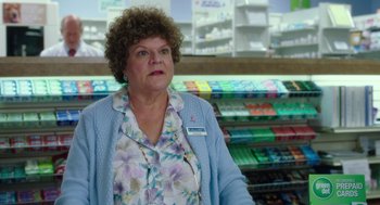 Movie still from “Blended” (2014), directed by Frank Coraci – A woman standing in front of a store with many shelves; Close Up shot, Over the shoulder angle