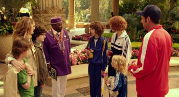 Movie still from “Blended” (2014), directed by Frank Coraci – A group of people standing in a garden area; Wide shot, Over the shoulder angle