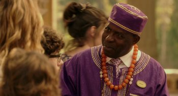 Movie still from “Blended” (2014), directed by Frank Coraci – A man wearing a purple hat and a necklace; Close Up shot, Over the shoulder angle