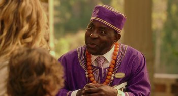 Movie still from “Blended” (2014), directed by Frank Coraci – An older man in a purple outfit talking to a woman; Close Up shot, Over the shoulder angle
