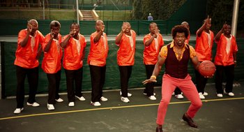 Movie still from “Blended” (2014), directed by Frank Coraci – A group of men standing on top of a tennis court holding rackets; Wide shot, Low angle
