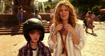 Movie still from “Blended” (2014), directed by Frank Coraci – A woman and a boy wearing a motorcycle helmet; Medium shot, Over the shoulder angle