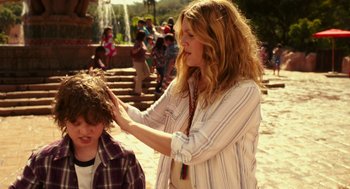 Movie still from “Blended” (2014), directed by Frank Coraci – A woman is touching a boy's hair outside; Medium shot, Over the shoulder angle