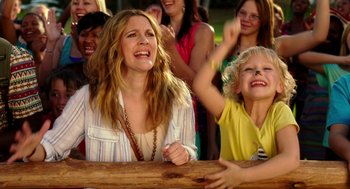 Movie still from “Blended” (2014), directed by Frank Coraci – A group of people standing around each other at a park; Medium shot, Over the shoulder angle