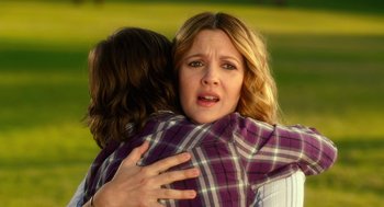 Movie still from “Blended” (2014), directed by Frank Coraci – A woman hugging another woman in a plaid shirt; Close Up shot, Over the shoulder angle