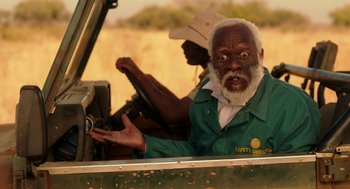 Movie still from “Blended” (2014), directed by Frank Coraci – An old man driving a truck with a surprised look on his face; Close Up shot, Over the shoulder angle