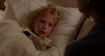 Movie still from “Blended” (2014), directed by Frank Coraci – A little girl laying in a bed with a stuffed animal; Close Up shot, High angle