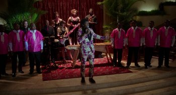 Movie still from “Blended” (2014), directed by Frank Coraci – A group of people are performing a song on a stage; Extreme Wide shot, High angle