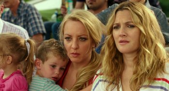 Movie still from “Blended” (2014), directed by Frank Coraci – Three women and a boy are sitting in a crowd; Close Up shot, Over the shoulder angle