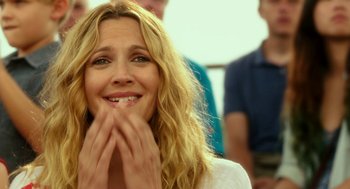 Movie still from “Blended” (2014), directed by Frank Coraci – A person smiling with her hands on her face; Close Up shot, Over the shoulder angle