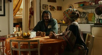 Movie still from “Blindspotting” (2018), directed by Carlos López Estrada – A man and a woman sitting at a table; Medium shot, Over the shoulder angle