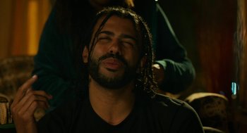 Movie still from “Blindspotting” (2018), directed by Carlos López Estrada – A man with dreadlocks sitting in front of a mirror; Close Up shot, Over the shoulder angle